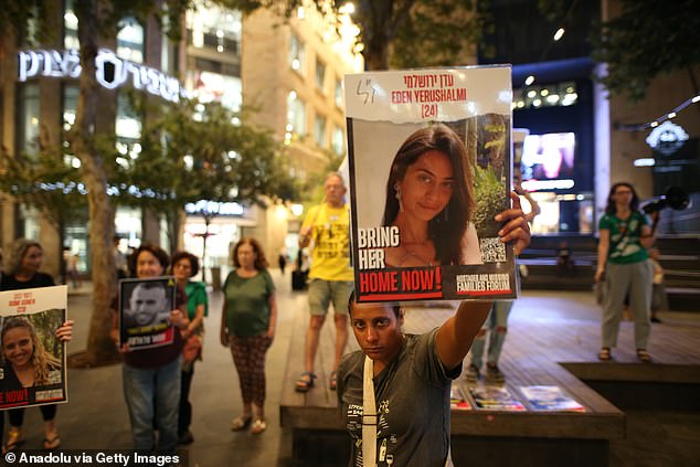 Pictured: Protesters carrying banners and photos of hostages gather outside the US embassy in Jerusalem on Tuesday.