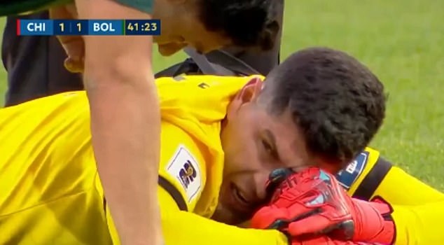 The goalkeeper was then carried off the pitch on a stretcher, visibly emotional with his head in his hands, as the brawl continued