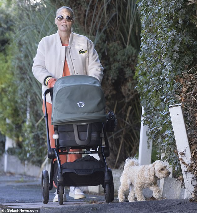 Meanwhile, Anne-Marie wore an orange tracksuit with a white Lacoste jacket as she pushed their little miracle in a stroller