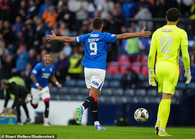 Rangers striker Cyriel Dessers runs off to celebrate after a chaotic few minutes