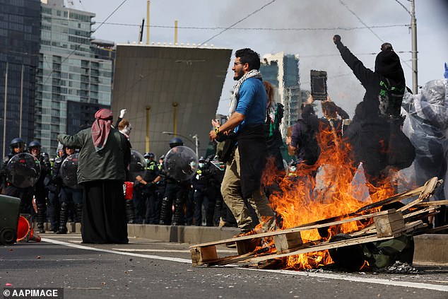 Protests descended into chaos in Melbourne on Wednesday, with demonstrators setting fire to rubbish