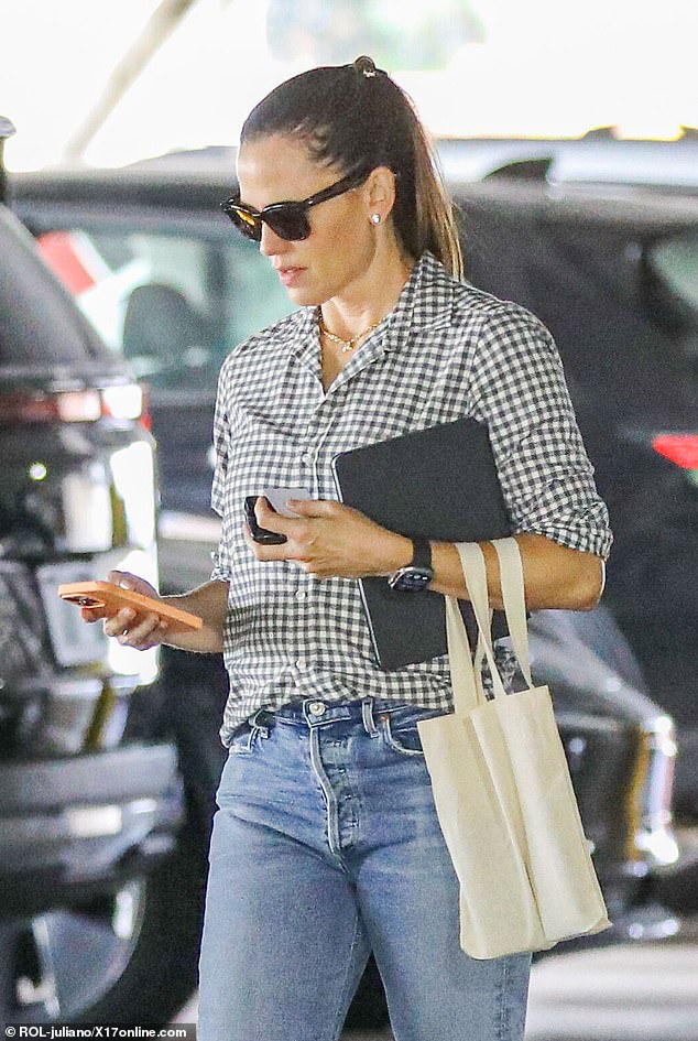 While she was presumably picking up her car, she appeared to be engrossed in her phone and checking a message