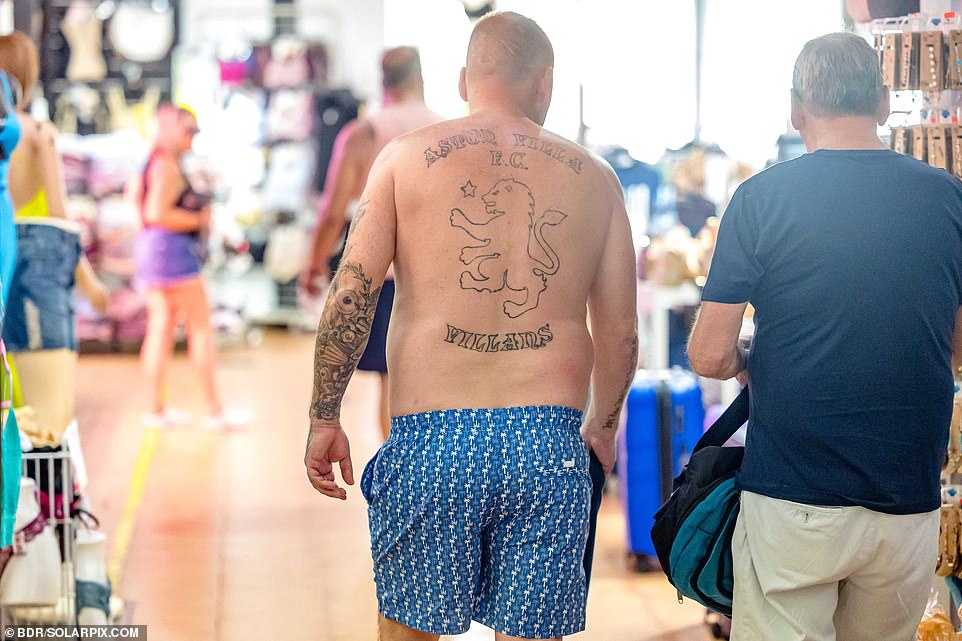 Shirtless Brits are a regular feature of the region in the summer. Here's one with an Aston Villa FC back tattoo