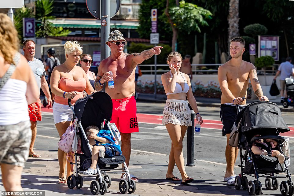 Benidorm is also known for catering to families. Pictured: People are seen pushing prams in the sun on Wednesday