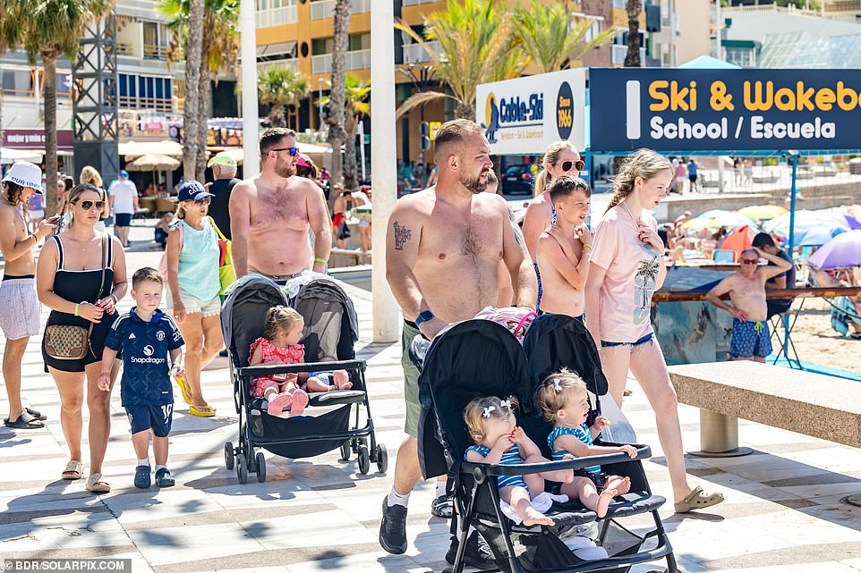 British holidaymakers and expats are seen pushing prams near Benidorm beach on Wednesday