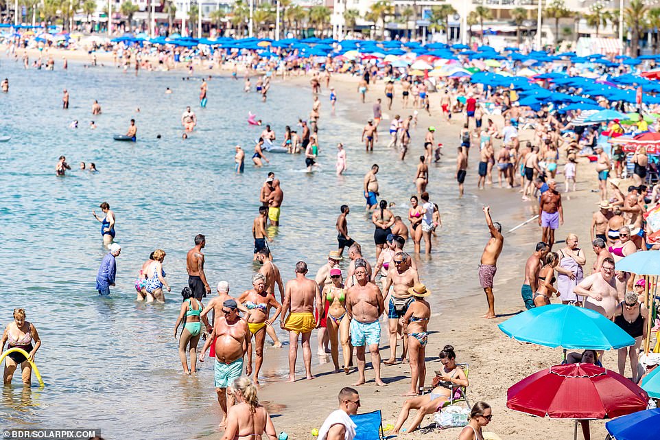 Hundreds of people enjoy the sun in Benidorm