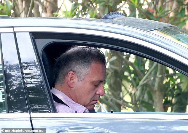 The disgraced television presenter, 52, was seen waiting patiently in the driver's seat of his car, with the window open, for his female companion to arrive