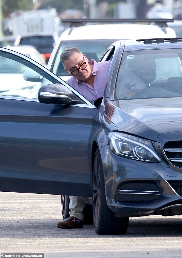 The former Deal Or No Deal presenter wore a smart casual look for the outing, wearing a pink shirt paired with beige trousers and brown boots