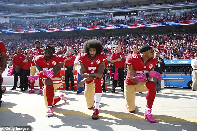 Colin Kaepernick (center) kneels in protest of police brutality in 2016