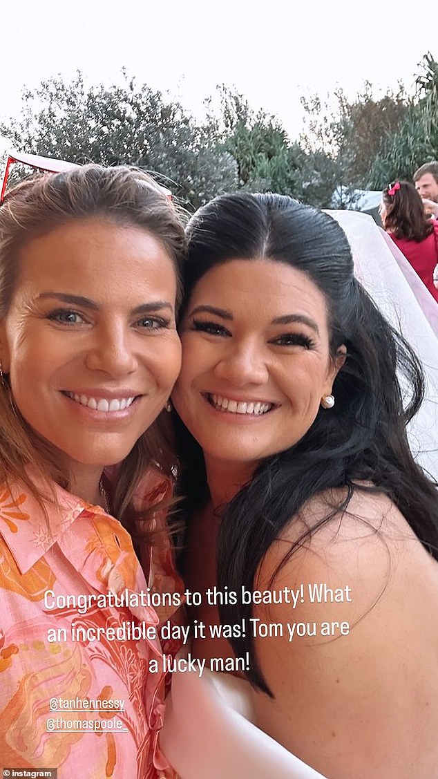 She completed the look with statement earrings and carried a beautiful bouquet of roses to say 'I do'. Pictured with Fiona Falkiner