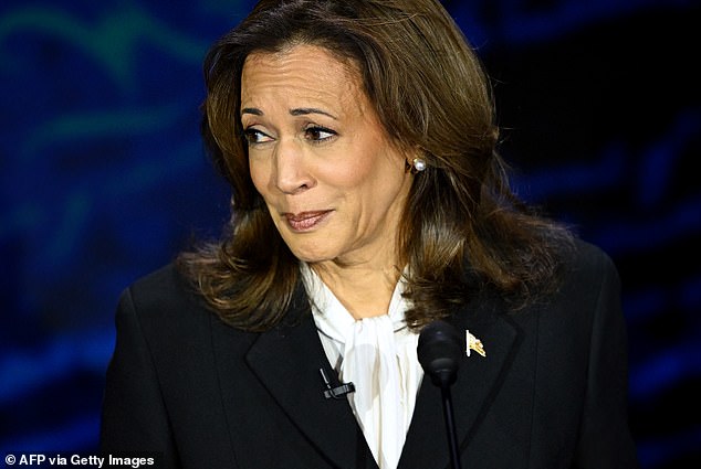 US Vice President and Democratic presidential candidate Kamala Harris reacts as former US President and Republican presidential candidate Donald Trump speaks during