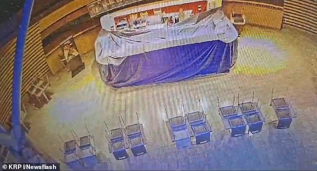 CCTV shows the suspect walking to a cubicle before someone else runs in. A security guard is said to have stopped him