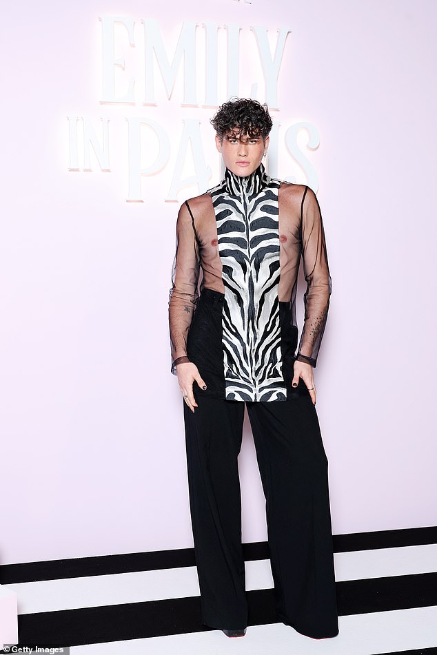 Raphael Say showed off a lot of skin in a mesh shirt with a zebra print scarf