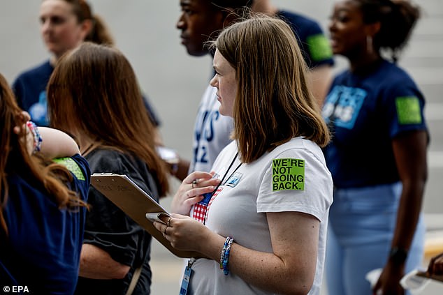 Volunteers receive instructions ahead of Kamala Harris' rally in Charlotte, NC. Many attendees wore stickers that read 