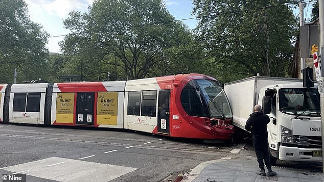 The tram's windshield was shattered and the front bumper was also damaged after being crushed by the side of the truck (photo)