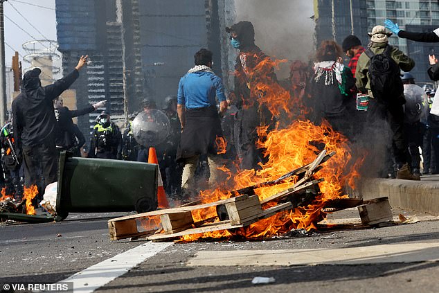 Protesters set fire to a wooden pallet during protests on Wednesday