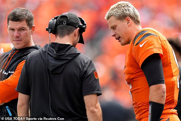 Burrow speaks with a coach on the sideline during Week 1 of the 2024 NFL season on Sunday.