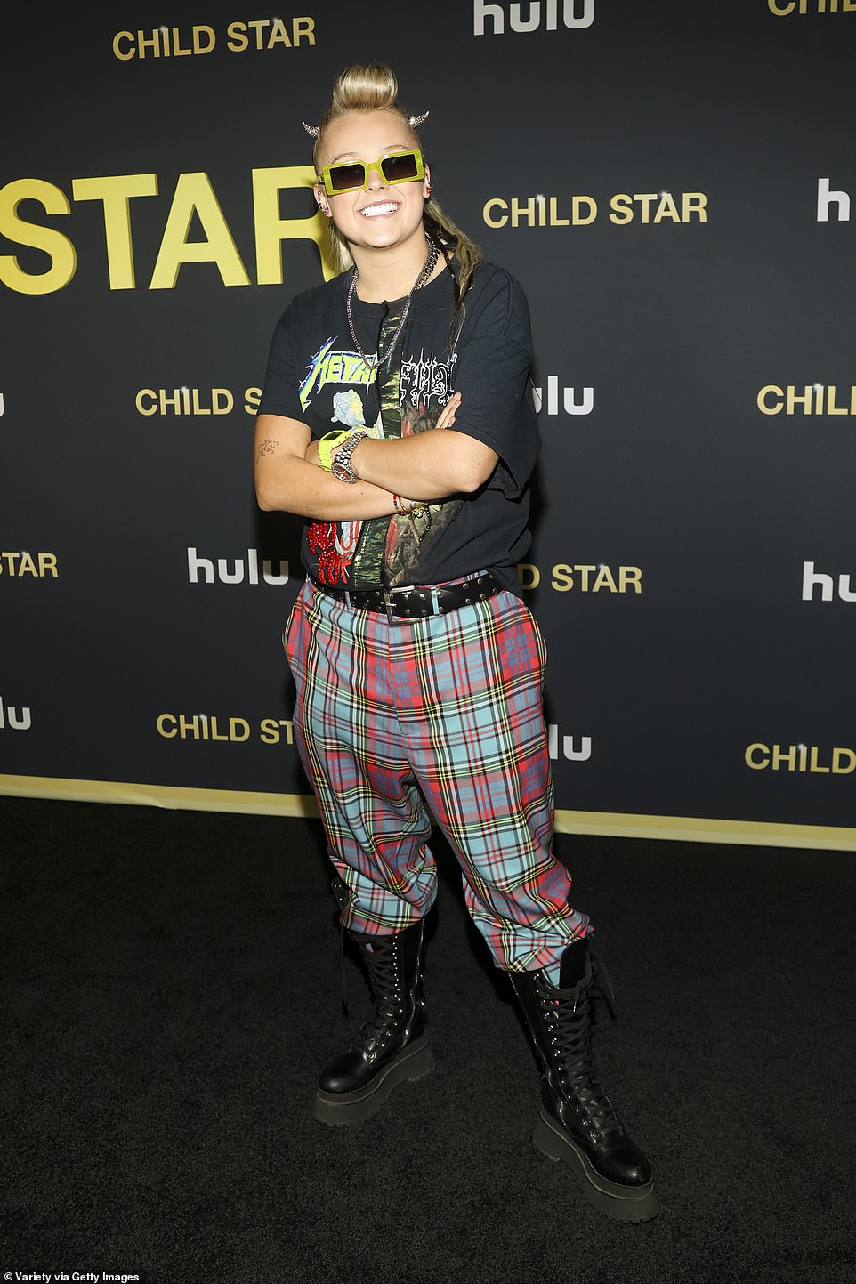 The 21-year-old YouTube sensation wore black platform boots, green sunglasses and several silver chains around her neck