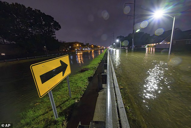 The West Napoleon Ave drainage canal can be seen at about the same level as the road that filled with floodwaters in Metairie, Louisiana, on Wednesday