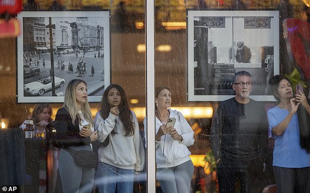 Frightened people watch Hurricane Francine from the Sheraton on Canal Street in New Orleans