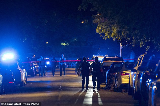 Chicago police investigate the scene where two officers were shot during a traffic stop in the 6300 block of South Bell in the West Englewood neighborhood, August 7, 2021