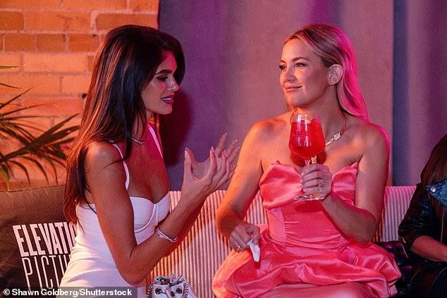 After earlier shining on the red carpet, the 45-year-old Hollywood actress kicked back with a cocktail as she joined the 23-year-old supermodel on the couch at the party