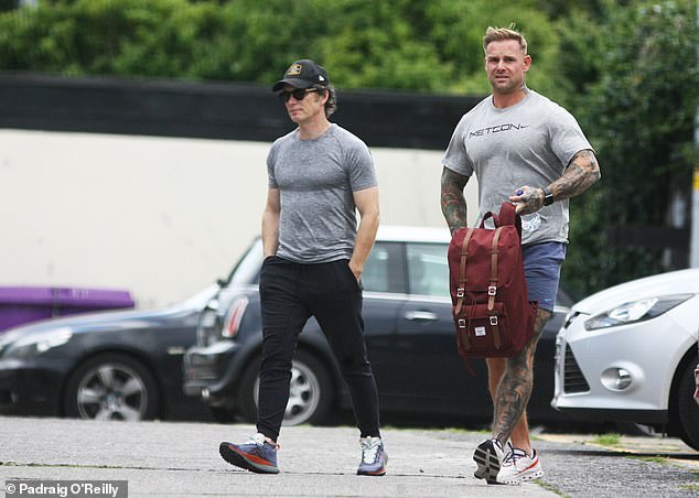 The Irish actor, 47, who played the lead role of Tommy Shelby in Peaky Blinders, showed off his toned figure under a grey T-shirt as he prepared to put on a pump