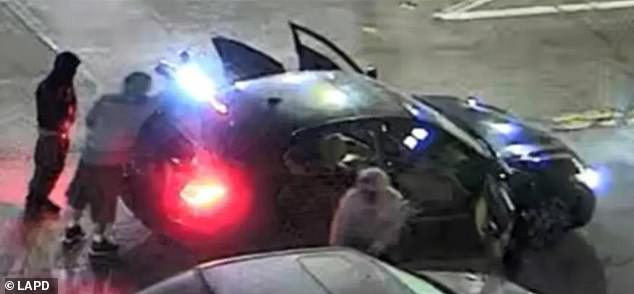 Los Angeles police previously released two images of the suspects and their getaway car (pictured above) while appealing for the public to help identify them.