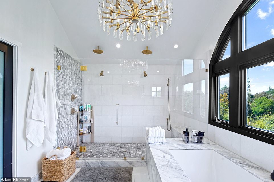 One bathroom features an elegant marble bath and a huge walk-in shower, while a large window also lets in plenty of natural light