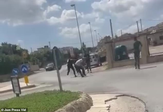 Another video shows the occupants of the car chasing the two gardeners away in front of a group of bystanders, who can be heard shouting in the background