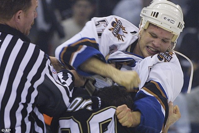 Peat, who faced the camera, worked as an enforcer in the NHL and often fought opponents