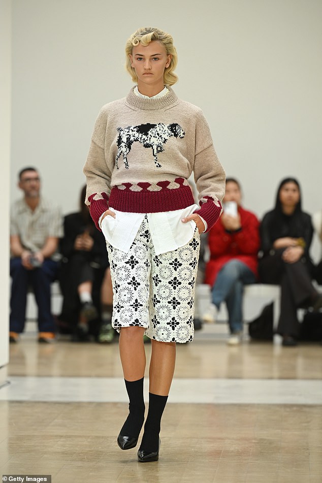 Model Mia Regan, 21, who previously dated Romeo Beckham, showed off her impressive modelling skills as she stormed the catwalk in a beige jumper with an embroidered dog in the middle