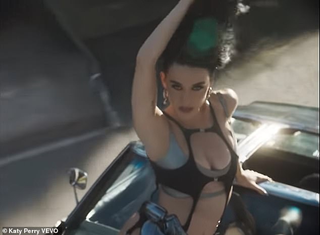 On Friday morning, the 39-year-old pop star released one of her sexiest music videos to date, which sees her kissing a handsome male model while lying in the middle of the street and dancing on top of a moving car in a black monokini