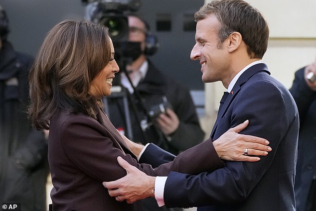 French President Emmanuel Macron, right, greets US Vice President Kamala Harris as she arrives for a conference