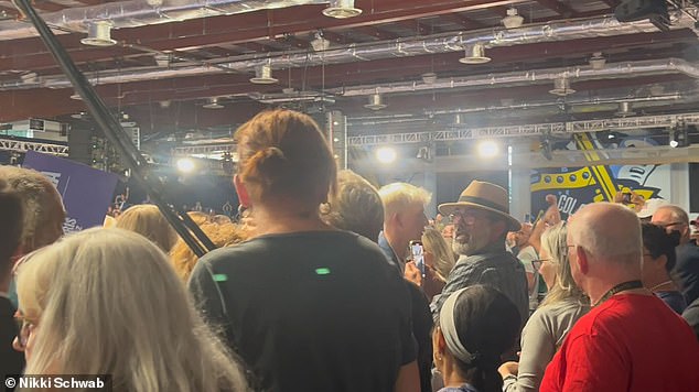 A second heckler (center, straw hat) interrupted Vice President Kamala Harris, shouting 