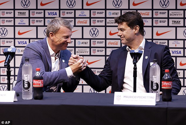 Mauricio Pochettino (R) shakes hands with US Soccer sporting director Matt Crocker (L)