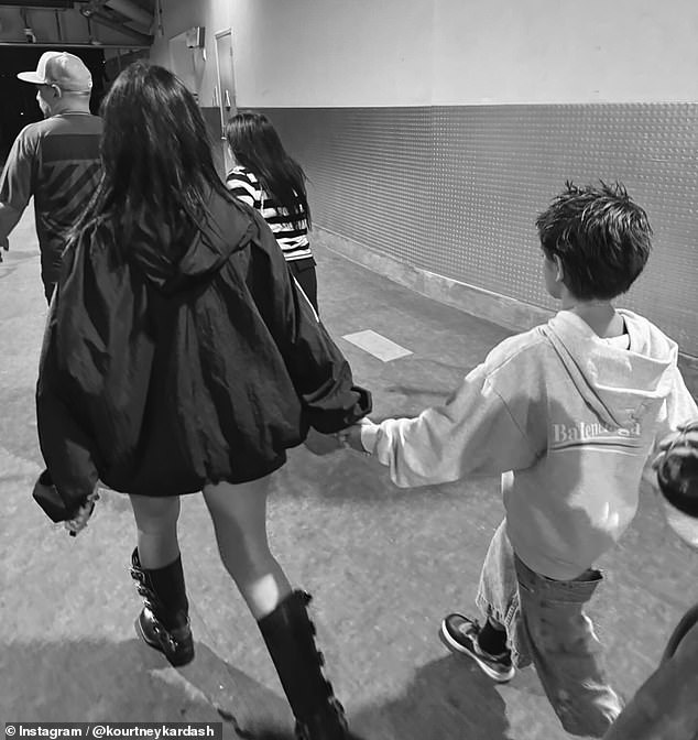 Kourtney's son, Reign, also appeared in the Instagram carousel and was seen holding his mother's hand as they were reportedly led backstage at one of Barker's concerts