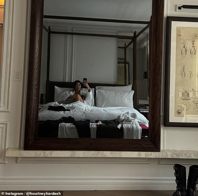 In another photo, Kourtney was seen taking a mirror selfie while lying in a comfortable bed with her son on her lap