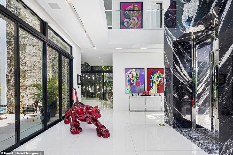 Natural light fills the spacious home with unique sculptures and modern art