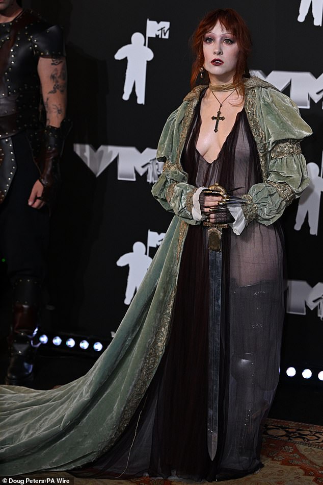 Before the ceremony, Chappell put a sassy spin on a medieval warrior princess costume, complete with a plunging chiffon dress, a large cross, pointed fingernails, gloves and a sword