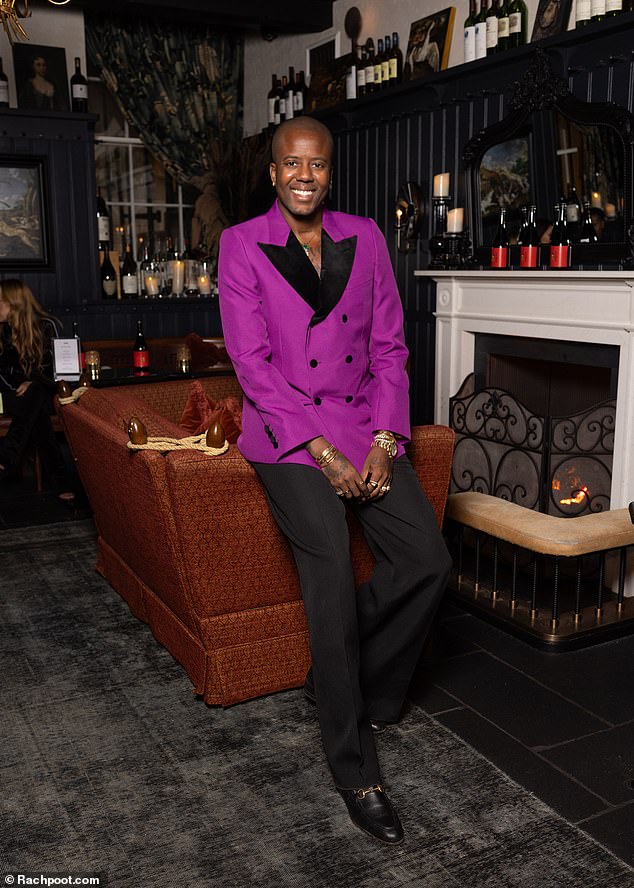 Vas was a vision in a striking purple tuxedo jacket as he posed happily in the glamorous surroundings