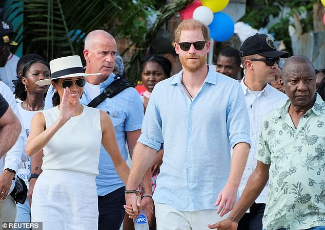 Where the Sussexes go, 'Langers' follow: seen here over their shoulder when they visited Colombia in August