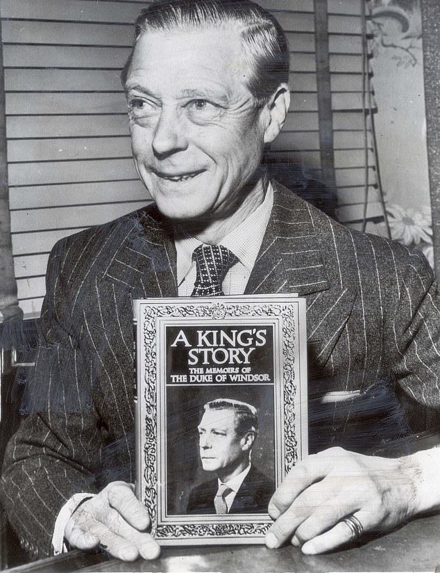 Former King Edward VIII, now the Duke of Windsor, holds up a copy of his 1951 memoir, A King's Story