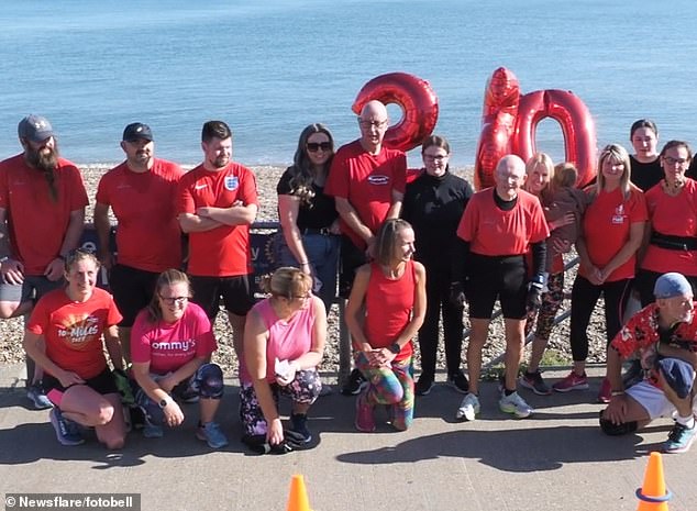 Fellow runners supported local legend Denis by wearing red tops and providing celebratory balloons at the finish line in Minster on Sea on the Isle of Sheppey, Kent