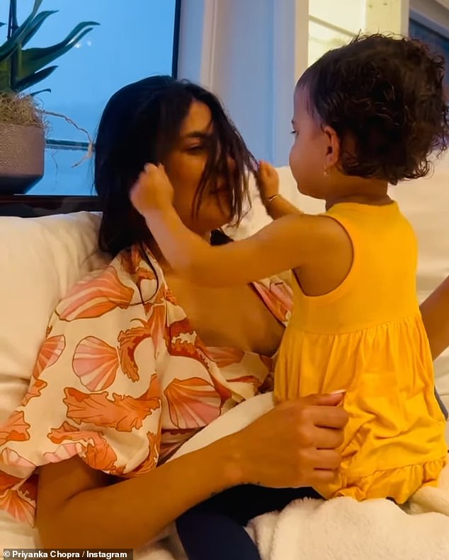 In another photo, the brunette beauty was seen playing with her daughter Malti, two, as the toddler happily played with her mother's long hair