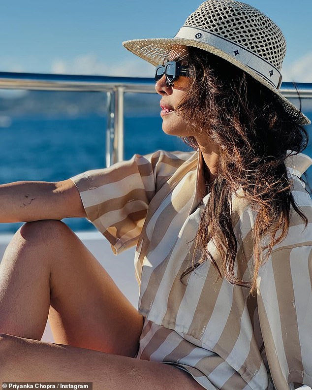 The actress looked stunning as she wore a woven hat and striped blouse in another photo from her vacation.