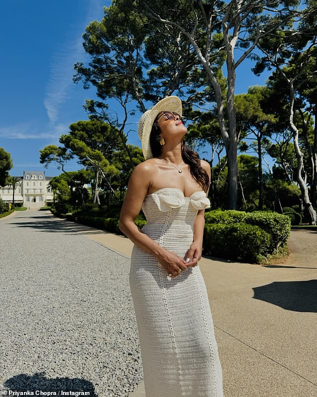 In a final photo after they stepped off the boat, Priyanka soaked up the sun in a long woven dress that matched her hat