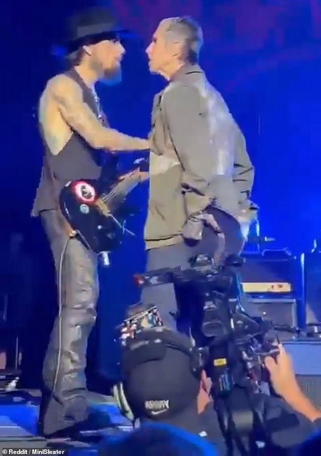 Perry Farrell, right, walked up to guitarist Dave Navarro, left, and began punching him during the shocking exchange in Boston on Friday