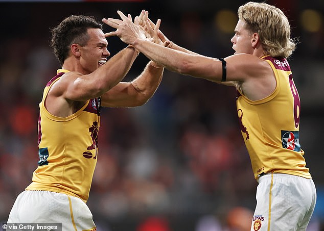 Lions' Cam Rayner (L) and Will Ashcroft (R) celebrate victory in the final match