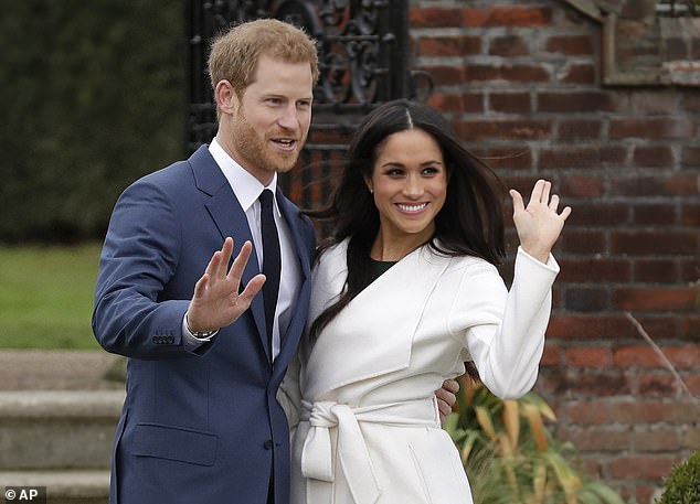 Britain's Prince Harry and his fiancée Meghan Markle pose for photographers during a photo call on the grounds of Kensington Palace in London, Monday, November 27, 2017.